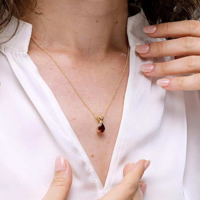 Elegant pear-shaped garnet solitaire pendant in silver, gold, or platinum. Perfect January birthstone gift for birthdays, anniversaries, or weddings. Elegant pear-shaped garnet solitaire pendant in silver, gold, or platinum. Perfect January birthstone gift for birthdays, anniversaries, or weddings.