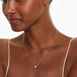 A 0.50 CTW diamond appears to float in a secure 14K white gold bezel setting. Adjustable 16-18" chain.