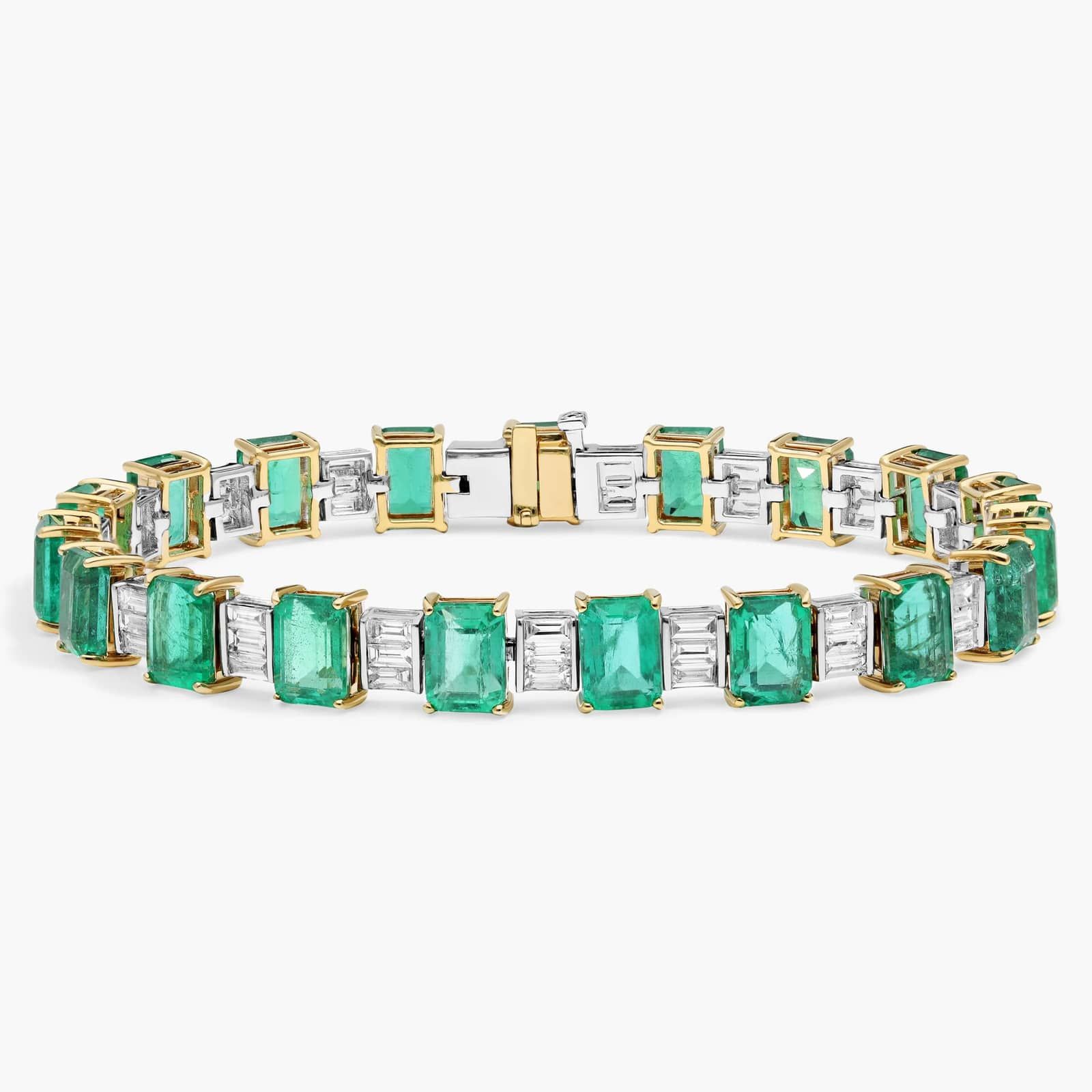 Heirloom Emerald and Diamond Baguette Bracelet A breathtaking masterpiece featuring 19 vibrant green emeralds and over two carats of brilliant baguette diamonds set in polished 18k white gold.