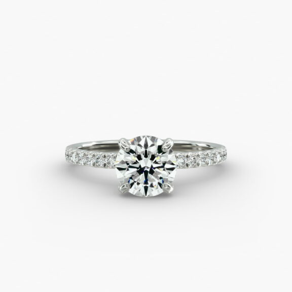 The Petite Pavé Crown hidden halo engagement ring in platinum with a round diamond.