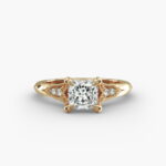 A macro shot of a GIA 3.03 carat princess diamond vintage-style ring on a white background, highlighting the intricate fleur-de-lis pavé details and the stunning clarity of the diamond.