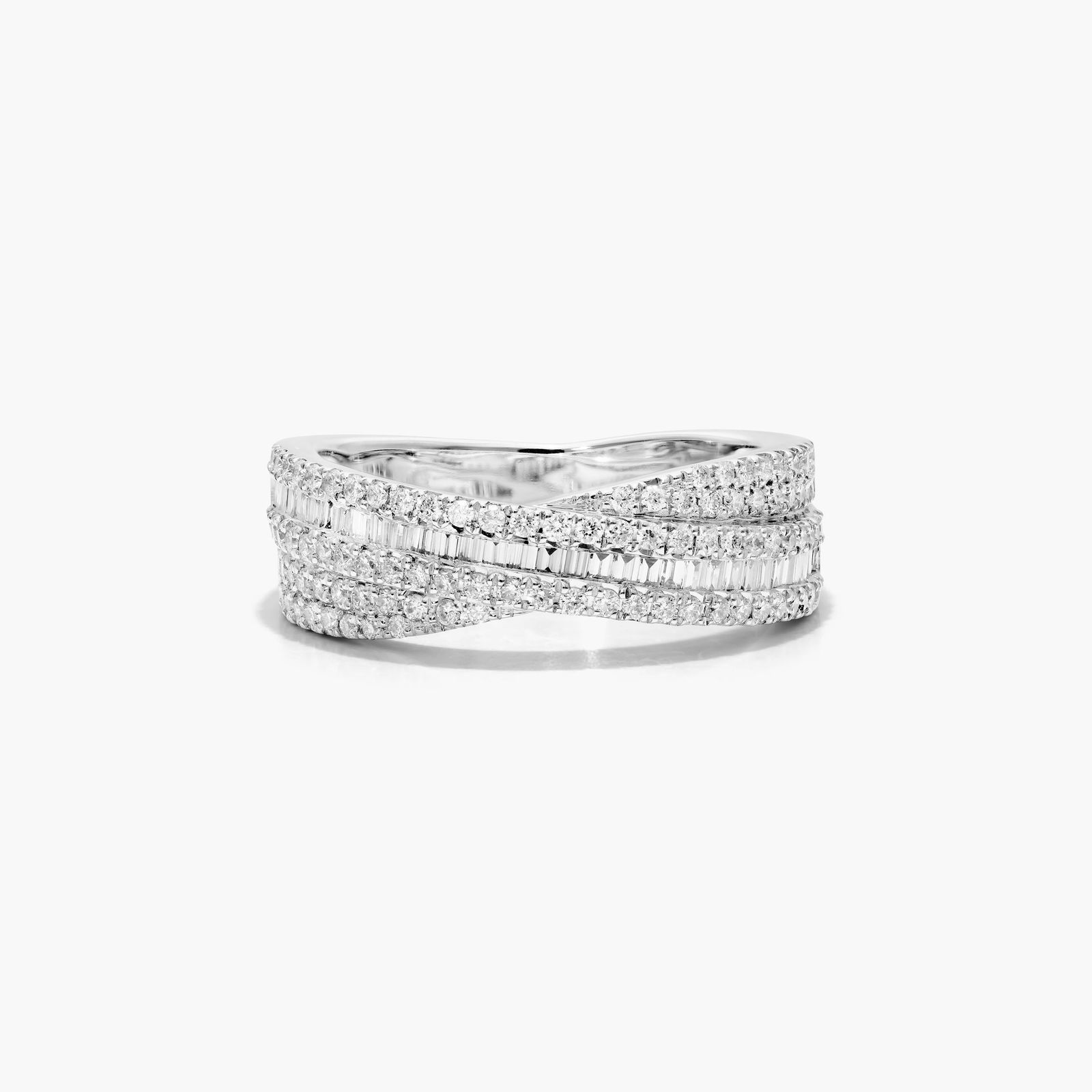 Cross Over Diamond Ring In 14K White Gold A wide crossover diamond ring in 14k white gold featuring interwoven bands of tension-set baguette diamonds and pavé-set round diamonds on a white background.