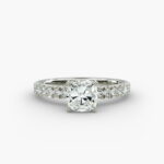 Close-up of a GIA 5.00 carat cushion modified diamond engagement ring on a white background, showcasing the intricate French pavé setting and the brilliant platinum craftsmanship.