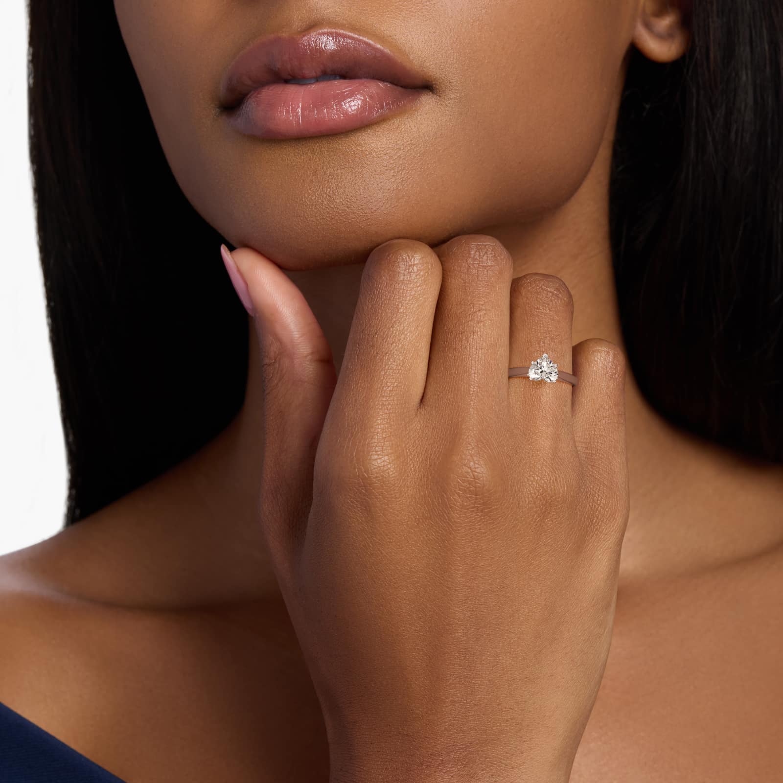 A woman's hand wearing a majestic **7 carat diamond ring**, showcasing the large heart-shaped diamond in a platinum cathedral solitaire setting.