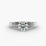 A close-up studio shot of a **Hearts and Arrows Diamond Engagement Ring**, highlighting the precise cut of the main diamond and the sleek, geometric lines of the tapered baguette side diamonds in a platinum setting.