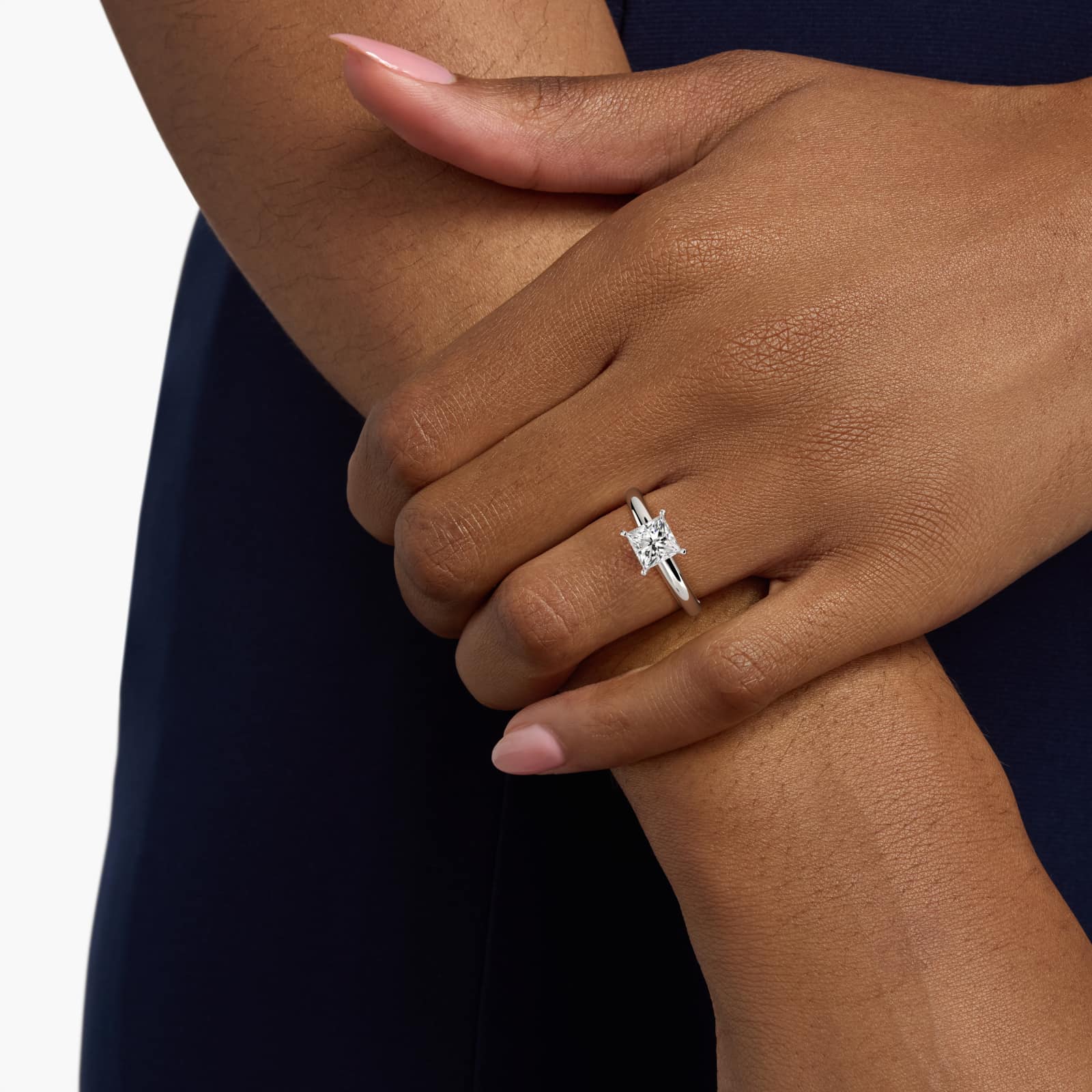 Classic Solitaire 2 Carat Princess Cut Lab-Grown Diamond Engagement Ring in 14k White Gold model A hand wearing a classic 2 carat princess cut lab-grown diamond engagement ring, showing off the E-VVS1 center stone.