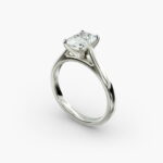 A close-up side view of a 4 carat radiant cut diamond ring, highlighting the secure prongs and the tapered 14k white gold band.