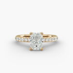 A close-up side view of a 3ct radiant cut diamond ring, showcasing the narrow 1.80mm yellow gold band and the subtle micropavé sparkle.