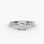 A close-up studio shot of a **7 carat diamond ring**, highlighting the sharp corners of the Princess cut diamond and the delicate detail of the French pavé side stones.