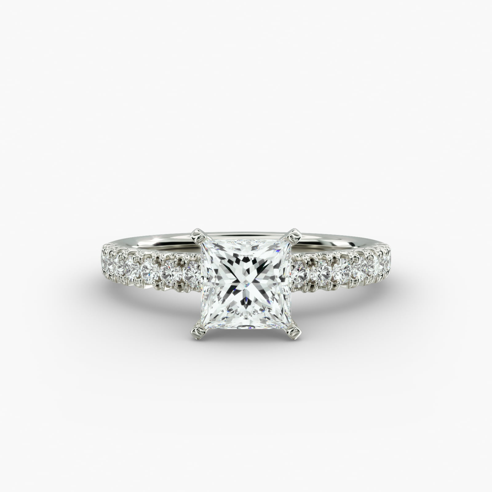 A close-up side view of a 2 carat princess cut diamond engagement ring, highlighting the F-VVS1 clarity of the center stone and the detailed French pavé setting.