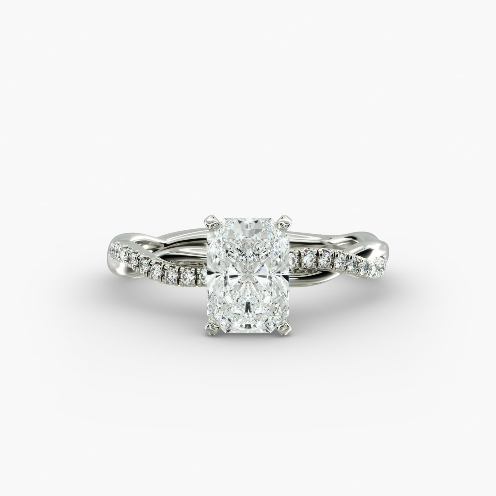 A close-up side view of a 2 carat radiant cut diamond ring, highlighting the F-VS1 clarity of the center stone and the elegant twist setting.