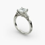 A close-up studio shot of a 2 carat princess cut diamond engagement ring, highlighting the straight lines of the princess and baguette diamonds set in 14K white gold.