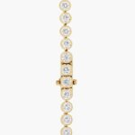 A spectacular lab created diamond tennis necklace featuring 20 CTW of F-G/VS2-SI1 round lab-grown diamonds in an illusion setting, handcrafted in radiant 14K Yellow Gold.