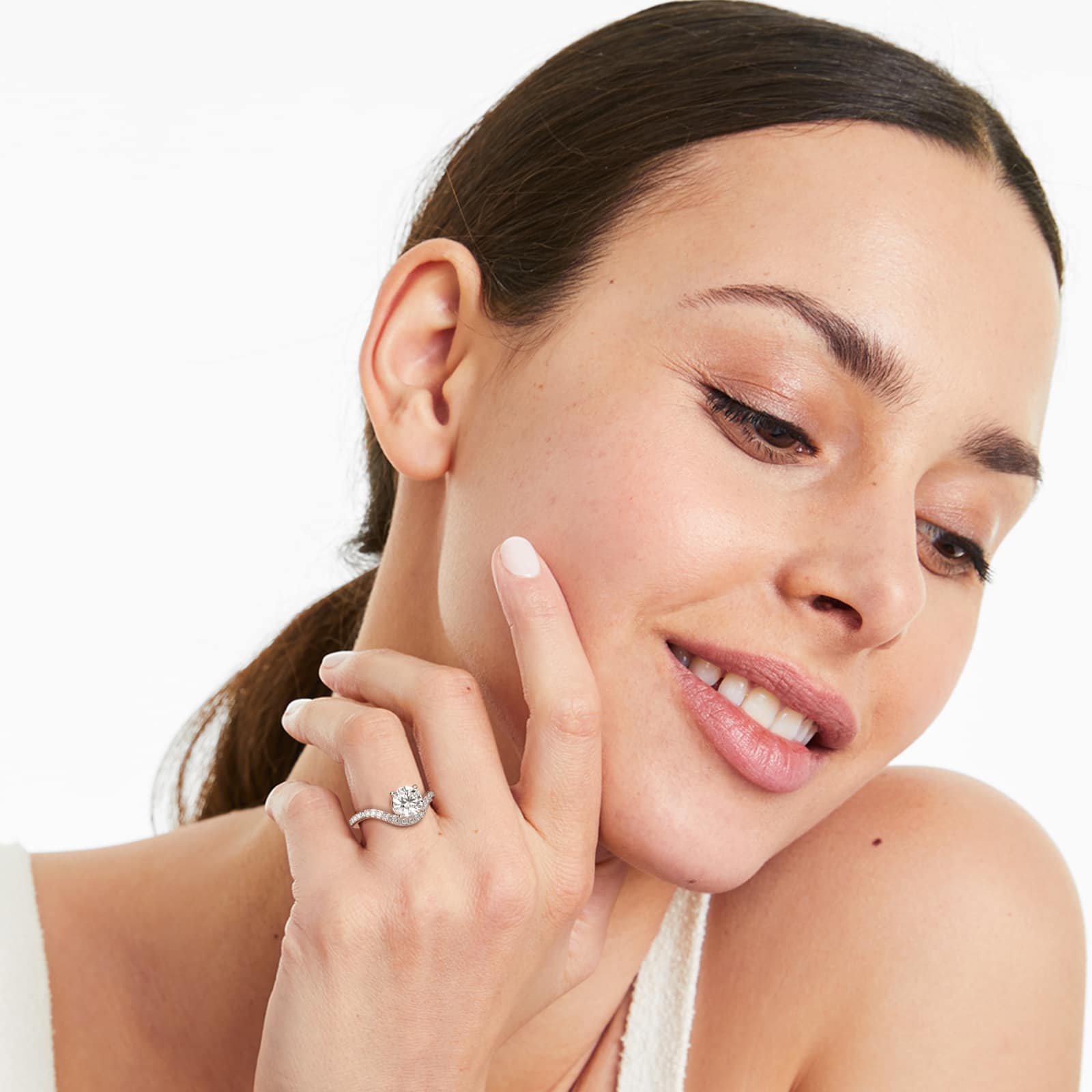A woman's hand wearing an enormous James Allen 4 carat diamond ring, a D-VVS1 round lab-grown diamond set in a white gold Sculptural Waves pavé band.
