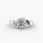 A close-up side view of a 4 carat diamond ring, highlighting the Triple Excellent cut of the center stone and the delicate pavé setting.