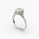 A close-up side view of a 4 carat diamond ring, highlighting the Triple Excellent cut of the center stone and the delicate pavé setting.