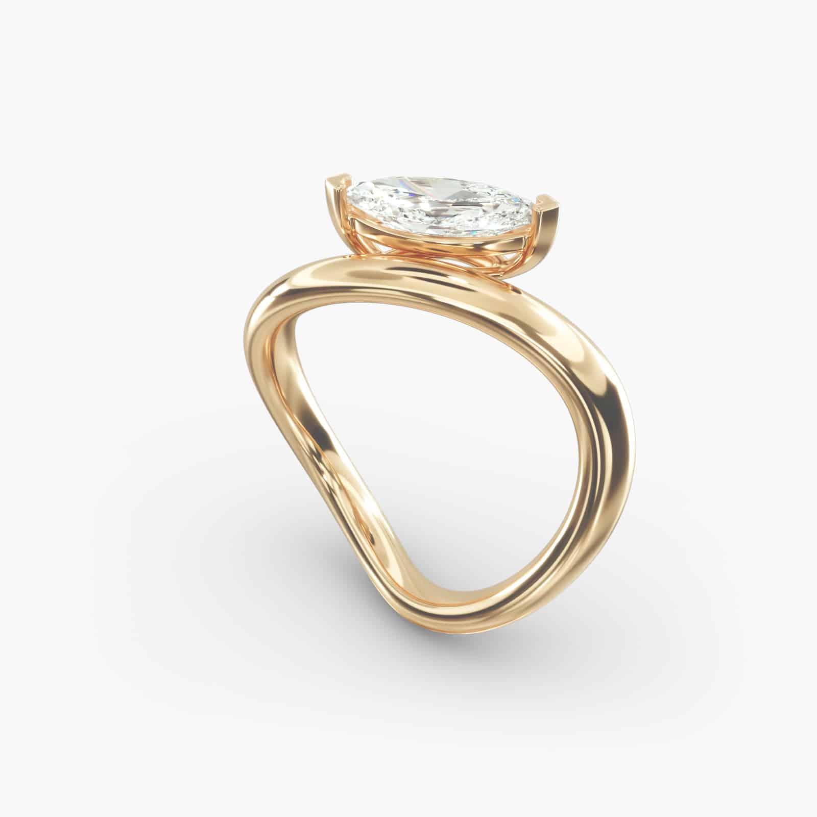 A close-up view of the marquise shaped diamond with prominent claw prongs on the Sculptural Waves yellow gold band.