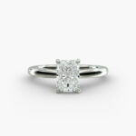 A close-up side view of a 6 ct radiant cut diamond ring, showcasing the delicate 1.60mm band and the hidden halo accent diamonds.