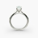 A close-up side view of a 6 ct radiant cut diamond ring, showcasing the delicate 1.60mm band and the hidden halo accent diamonds.