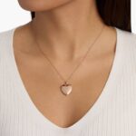 A closed 18-inch Sweetheart Locket with a single diamond accent in 14K Rose Gold, a romantic example of Luxury Push Present Ideas for a new mother.