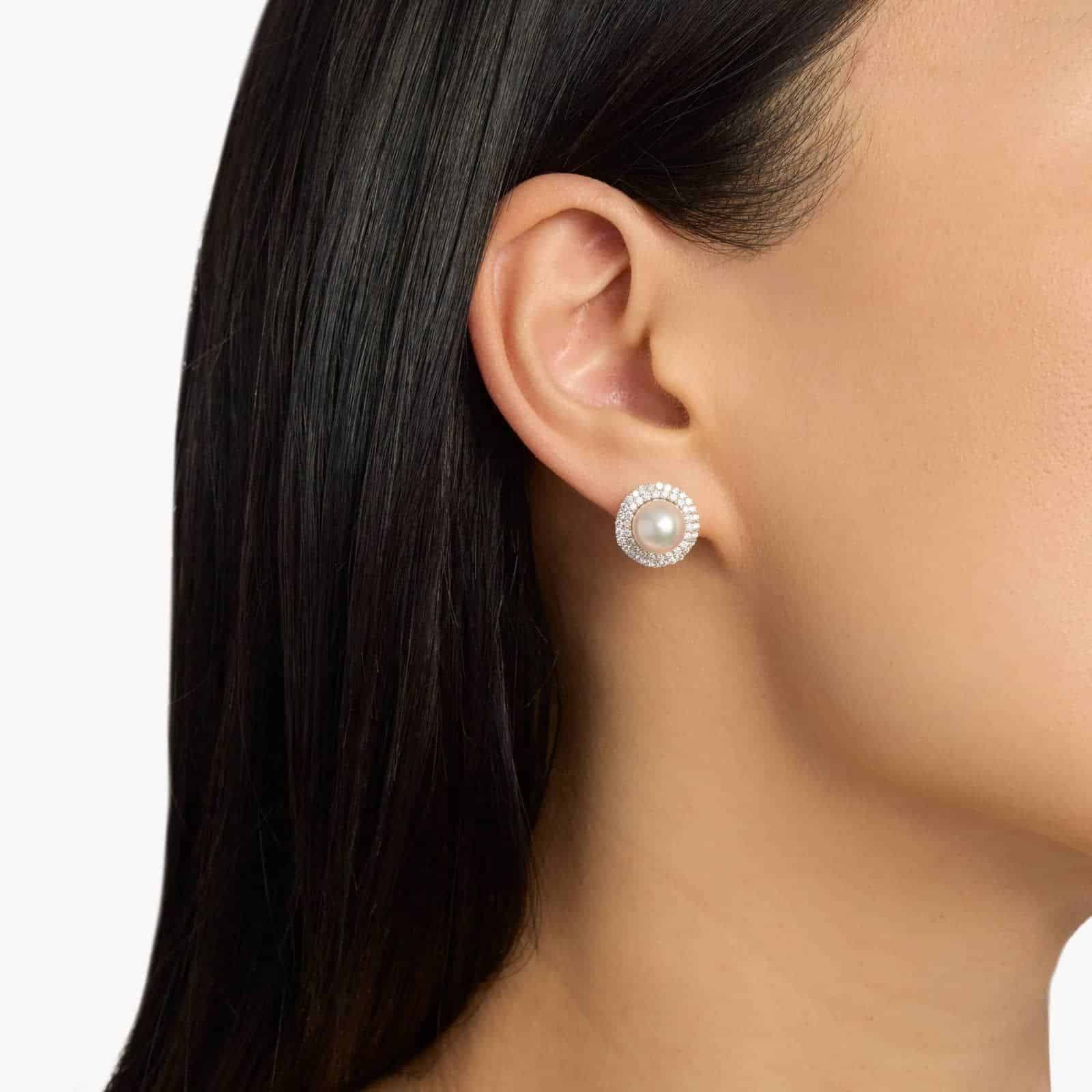 A model wearing the large 8.5mm Akoya Pearl and Diamond Double Halo Earrings, showcasing the impressive size and brilliant sparkle near the earlobe.