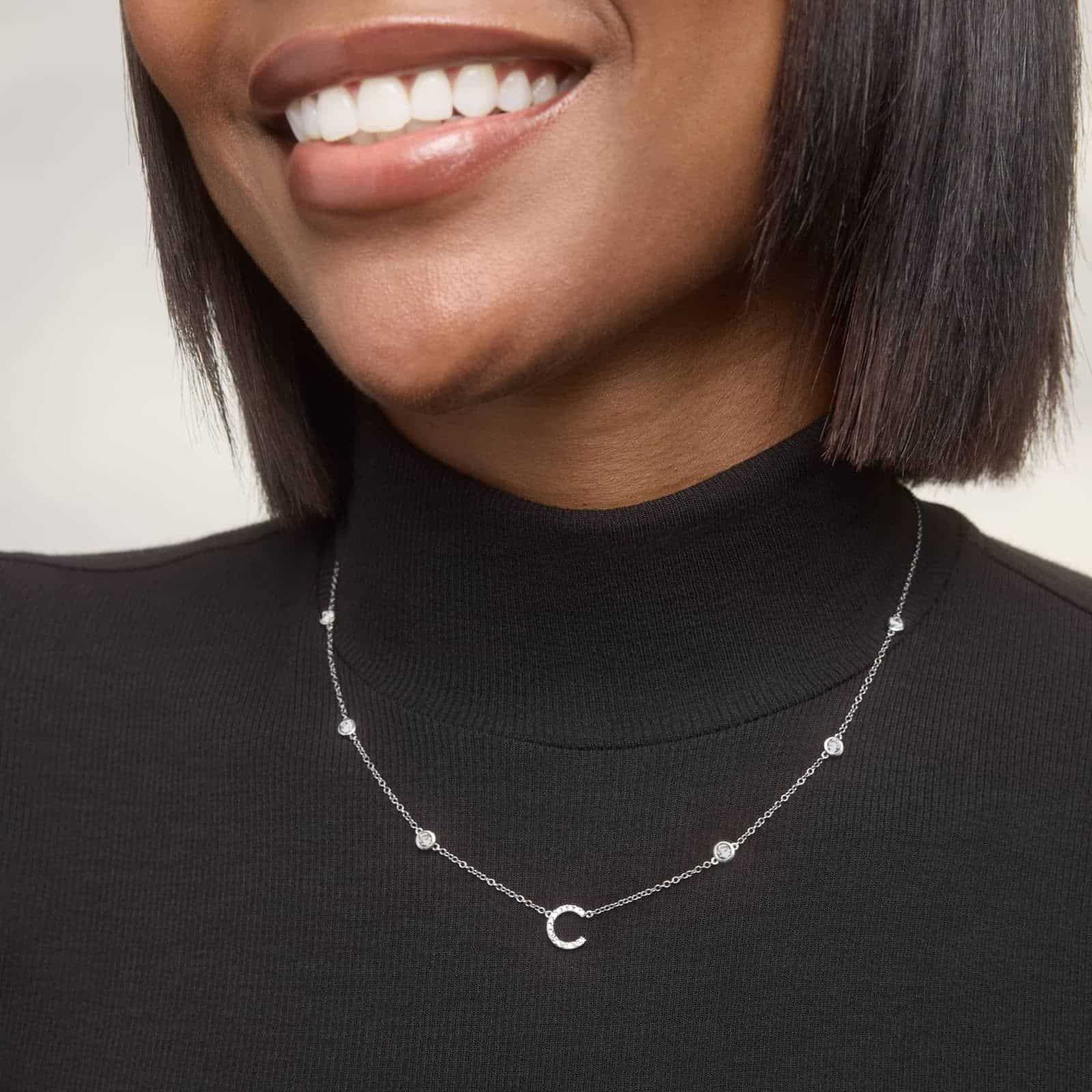 A personalized station initial necklace in 14K White Gold featuring 0.95 CTW lab-grown diamonds in a bezel setting, one of the best Luxury Push Present Ideas.