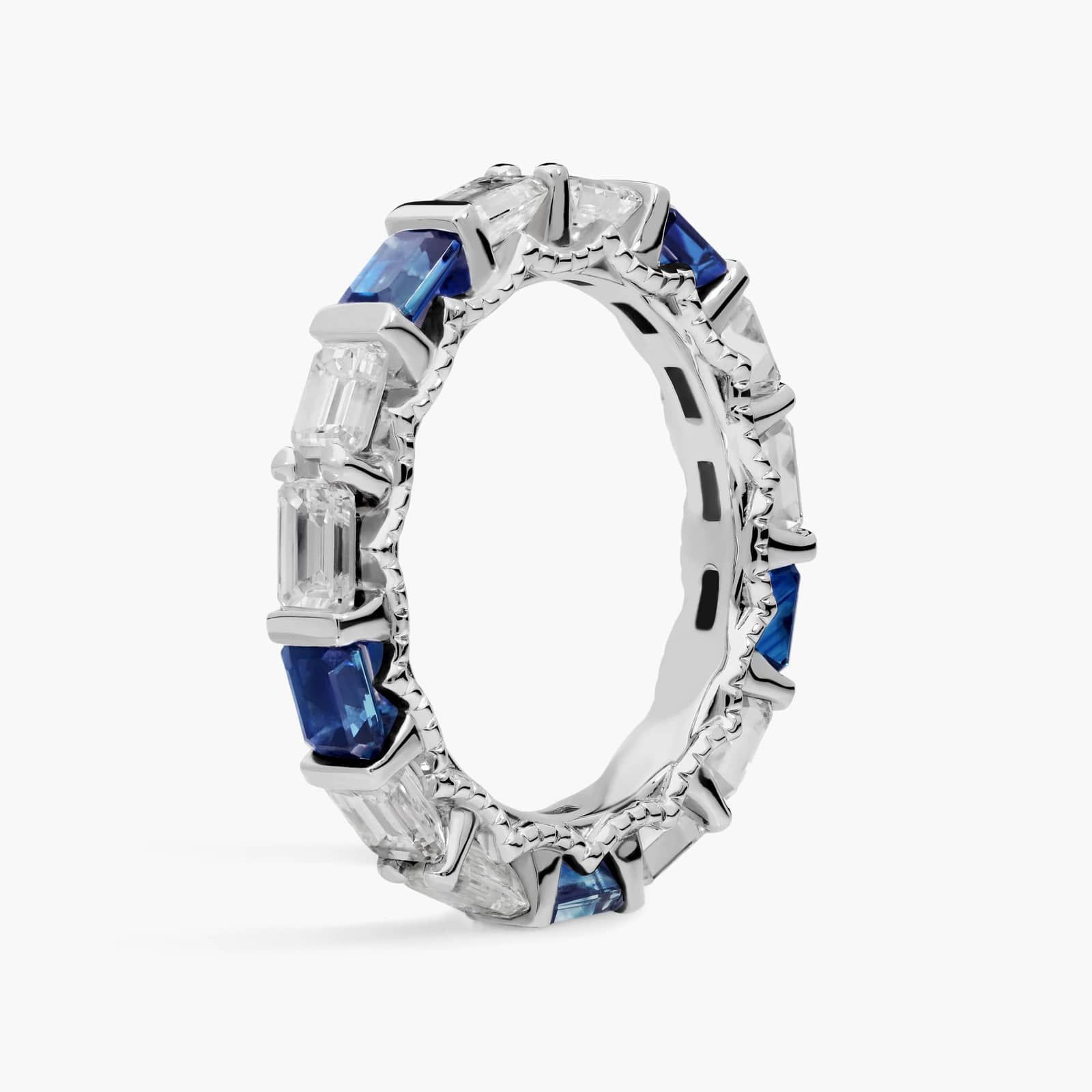 alternating-emerald-cut-sapphire-diamond-blue-wedding-rings-for-women 2 An Alternating East-West Emerald Cut Sapphire and Diamond Blue Wedding Rings For Women band (3.30mm) in 14K White Gold with over 2.5 CTW of stones.