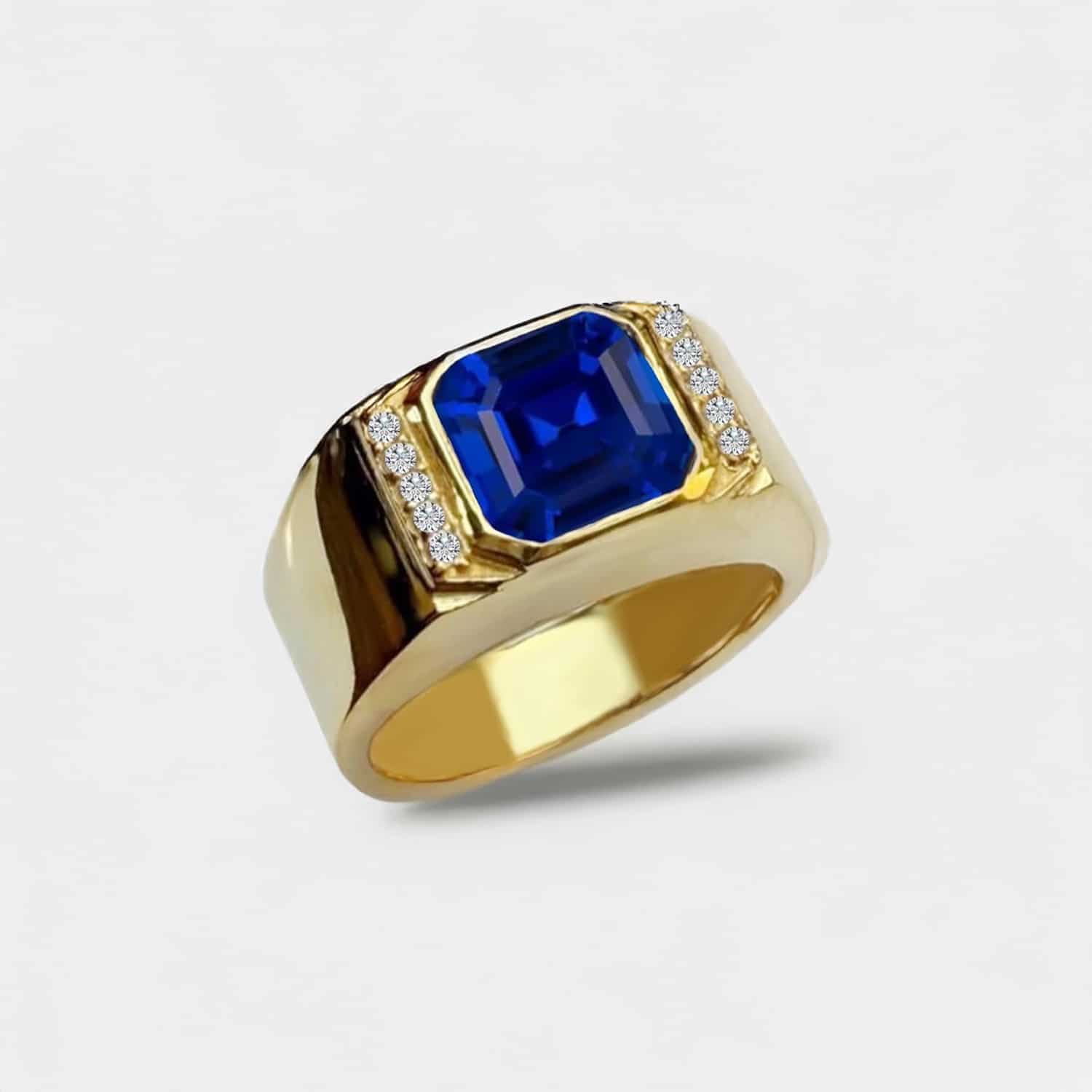 asscher-cut-blue-sapphire-bezel-set-mens-gold-ring-with-blue-sapphire-2-carat A Yellow Gold Mens Gold Ring With Blue Sapphire featuring a 2 Carat Square Asscher Cut Blue Sapphire set in a secure Bezel Setting, marketed as a men's engagement and wedding ring.