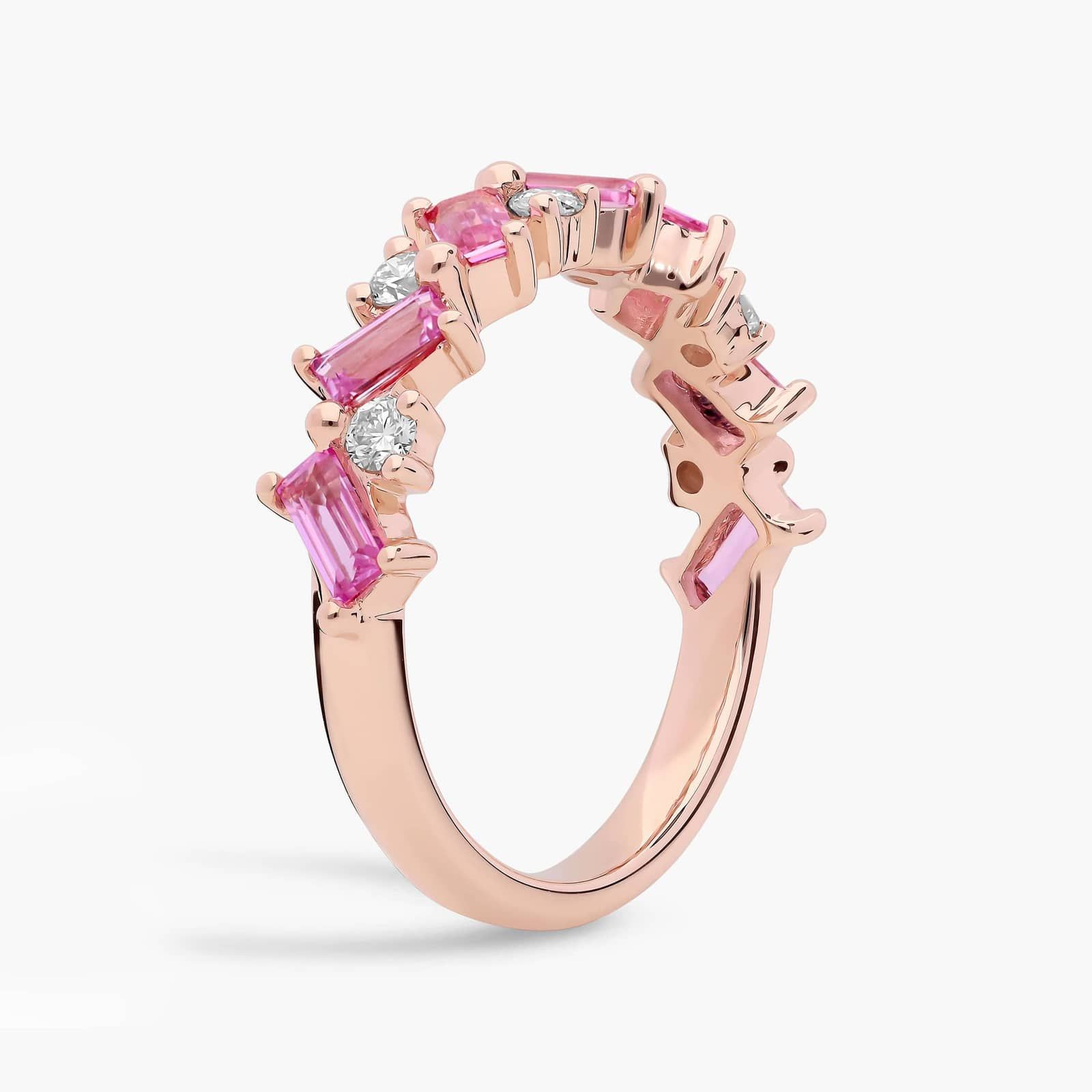 diamond-rose-gold-and-pink-sapphire-ring-emerald-cut-14k 2 A 14K Rose Gold and Pink Sapphire Ring featuring 7 Baguette Pink Sapphires and 6 Round Diamonds (0.18 CTW) set in prongs, creating a romantic, emerald-style look on a 2.50 mm band.