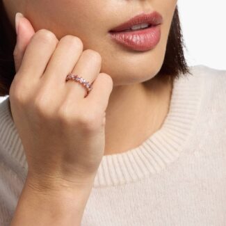 A 14K Rose Gold and Pink Sapphire Ring featuring 7 Baguette Pink Sapphires and 6 Round Diamonds (0.18 CTW) set in prongs, creating a romantic, emerald-style look on a 2.50 mm band.