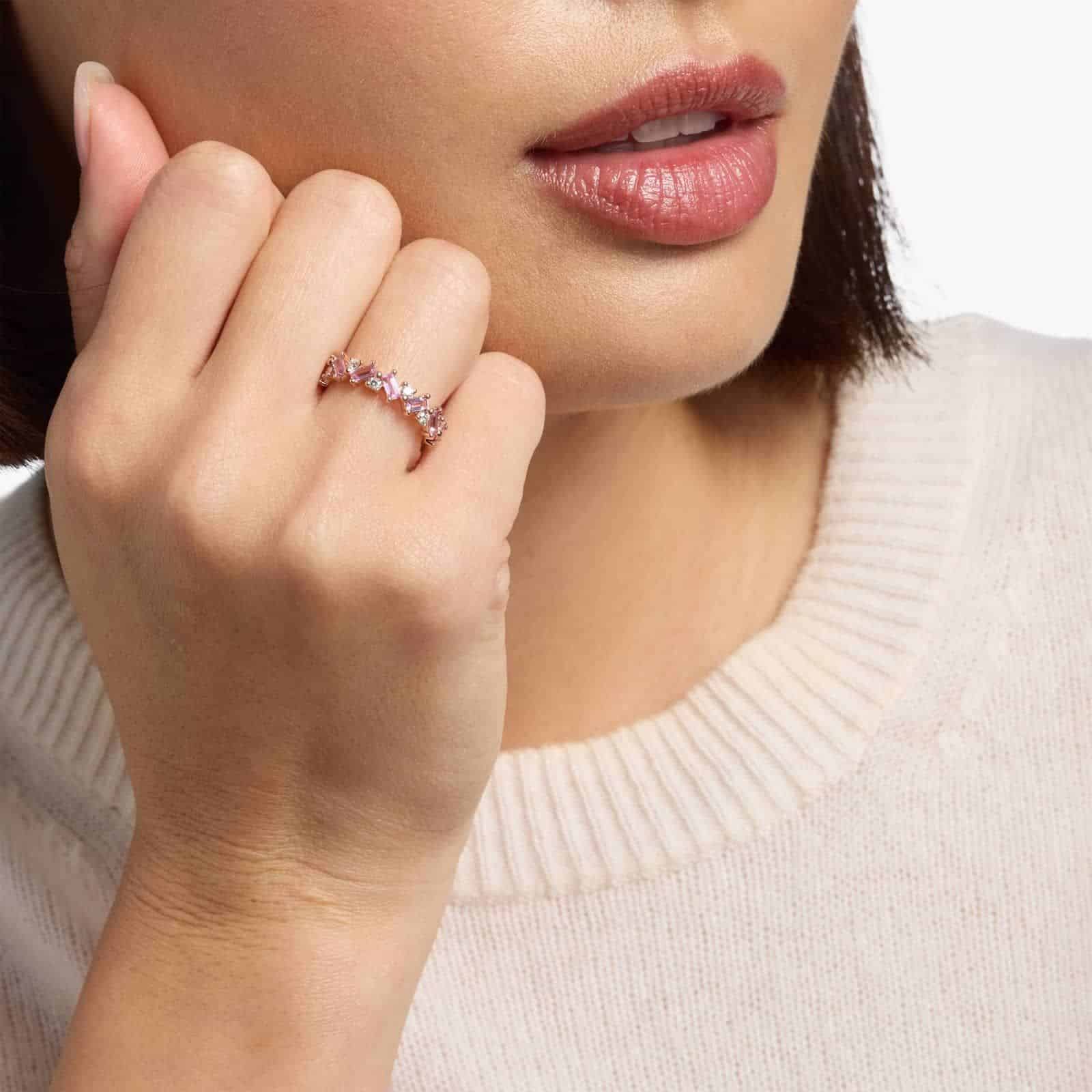 diamond-rose-gold-and-pink-sapphire-ring-emerald-cut-14k model view A 14K Rose Gold and Pink Sapphire Ring featuring 7 Baguette Pink Sapphires and 6 Round Diamonds (0.18 CTW) set in prongs, creating a romantic, emerald-style look on a 2.50 mm band.