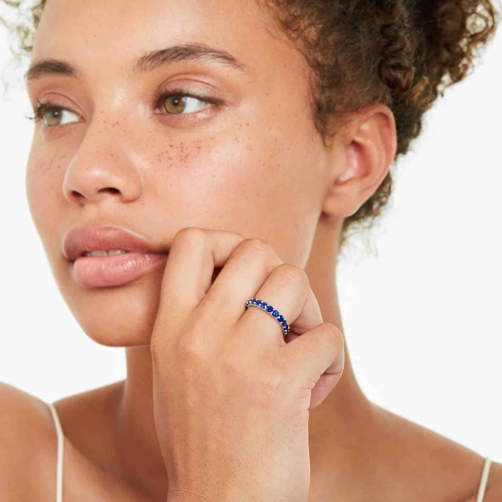 A 14K White Gold Blue Sapphire and Diamond Wedding Ring Sets component: a 3.00 mm Milgrain Embellished Eternity Band with 2.25 Carat minimum Round Blue Sapphires and 0.11 CTW diamond accents.
