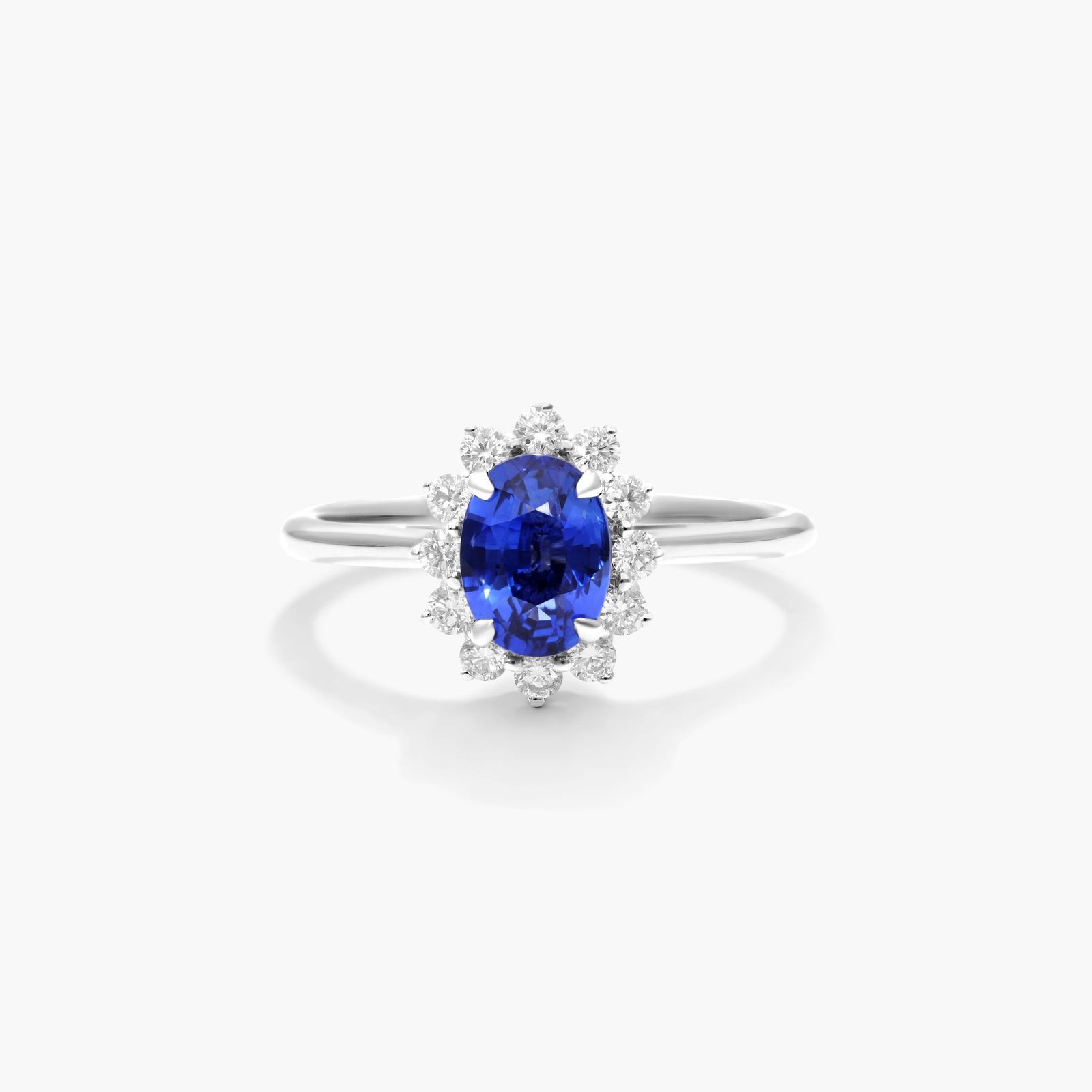 oval-halo-engagement-rings-with-diamonds-and-sapphires-18k-white-gold An 18K White Gold Oval Halo Engagement Rings With Diamonds and Sapphires ring featuring a 1.05 Carat Oval Blue Sapphire center stone and a 0.27 Carat Total Weight round diamond halo.
