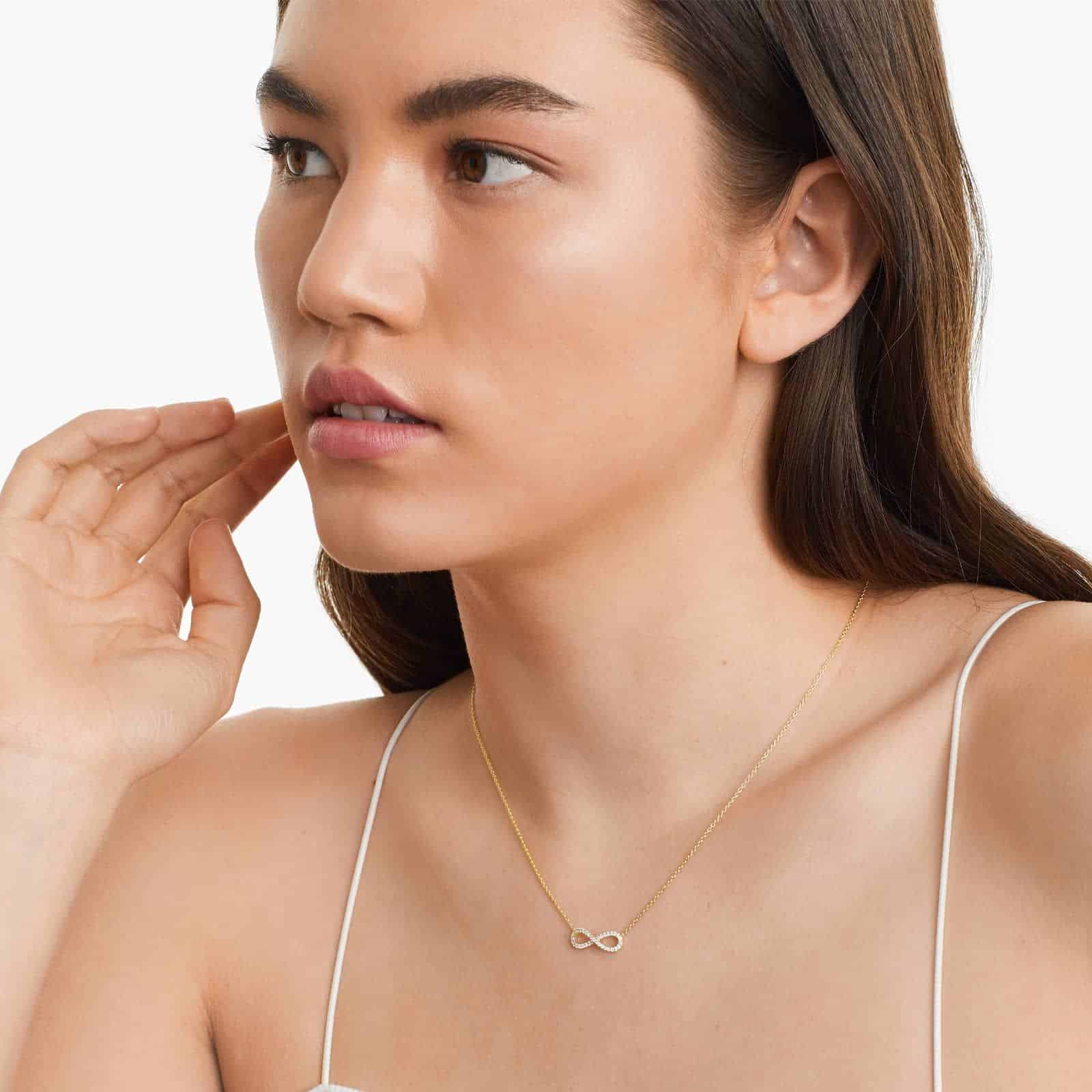 pave-diamond-infinity-necklaces-valentines-day-jewelry-for-her-14k-yellow-gold MODEL VIEW 14K yellow gold infinity necklaces valentine's day jewelry for her featuring a diamond pavé infinity symbol on a 16-inch cable chain.