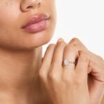 Platinum oval solitaire engagement rings under $2,500 featuring a 1.5 carat colorless VS clarity lab grown diamond with claw prongs and a flush fit band.