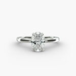 Platinum oval solitaire engagement rings under $2,500 featuring a 1.5 carat colorless VS clarity lab grown diamond with claw prongs and a flush fit band.