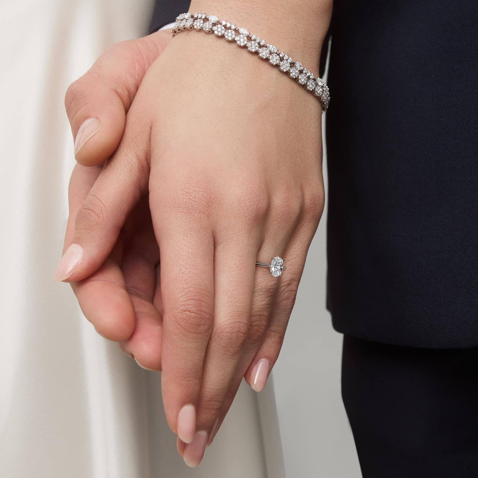 Oval Cut 1.5 CT Certified Lab-Grown Diamond Petite Solitaire Engagement Ring In Platinum model hand view Platinum oval solitaire engagement rings under $2,500 featuring a 1.5 carat oval lab-grown diamond on a 1.80mm petite band.