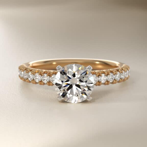14K yellow gold French pavé engagement rings under $2,500 featuring a 1 carat round lab grown diamond and 16 natural diamond accents.