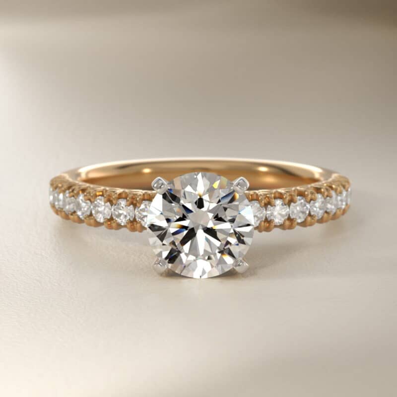 14K yellow gold French pavé engagement rings under $2,500 featuring a 1 carat round lab grown diamond and 16 natural diamond accents.