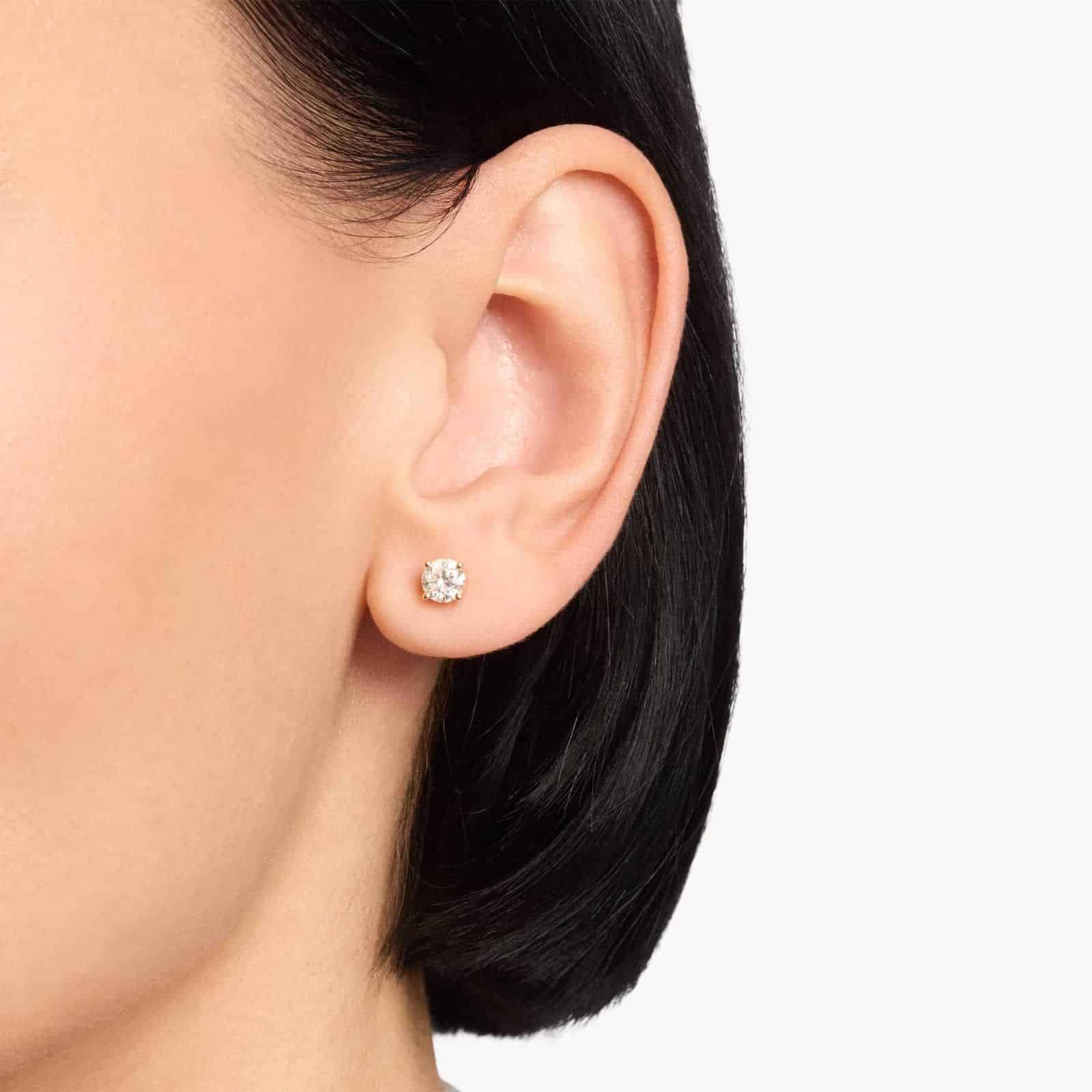 Enhance your everyday elegance with our stunning 1 ct total weight diamond earrings, featuring two brilliant round natural diamonds set in classic 14K yellow gold with secure Guardian backs.